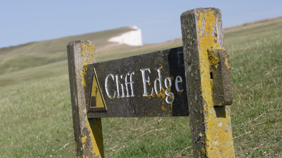 Cliff Edge sign on Beachy head coastline East Sussex England UK