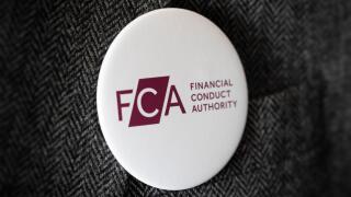 A button badge bearing the logo of FCA Financial Conduct Authority fastened to a suit jacket.