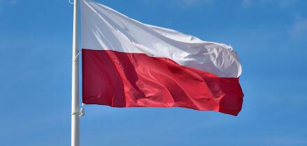 Polish flag against blue sky