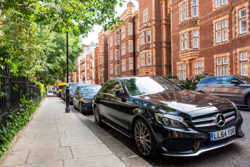 LONDON- JULY, 2020: Black Mercedes car  parked on beautiful street of Kensington townhouses
