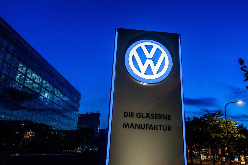 VW logo in front of Glaeserne Manufaktur, Transparent Factory, Volkswagen Factory, Auto manufacturing, Dresden, Saxony, Germany, Europe
