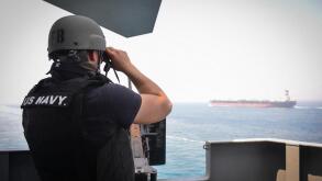 STRAIT OF HORMUZ (July 23, 2017) U.S. Navy Gunner's Mate 3rd Class Jalen Delgado, from Boston, observes passing ships aboard the aircraft carrier USS Nimitz (CVN 68), July 23, 2017, in the Strait of Hormuz. Nimitz is deployed in the U.S. 5th Fleet area of
