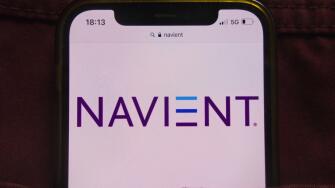 KONSKIE, POLAND - February 22, 2022: Navient Corporation logo displayed on mobile phone hidden in jeans pocket