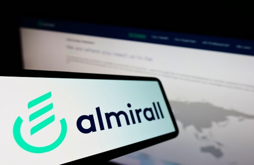 Cellphone with logo of Spanish pharmaceutical company Almirall S.A. on screen in front of business website. Focus on left of phone display.