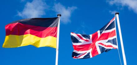 Flags of Germany and United Kingdom against blues sky