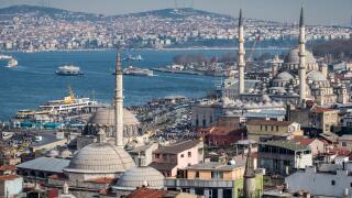 Istanbul skyline, the Bosphorus, ferries sailing towards the Aisian side, Rustem Pasha and Yeni mosques at Eminonou in foregroun