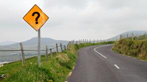 Yellow road sign with question mark