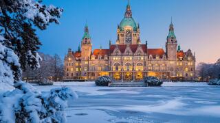City Hall of Hannover, Germany in winter with snow and frozen lake