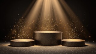 Dark, elegant podiums illuminated by golden spotlight
