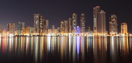 Skyline of Sharjah City at night, United Arab Emirates