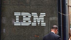 A businessman walks past the IBM building at 590 Madison Ave, New York in Midtown Manhattan.