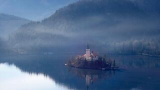 Slovenia. Aerial view over Lake Bled and the island with the pilgrimage church dedicated to the Assumption of Mary (Cerkev Marijinega vnebovzetja)