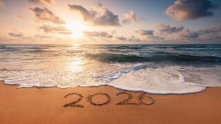 Happy New Year 2026 concept, lettering on the beach. Written text on the sea beach at sunrise.