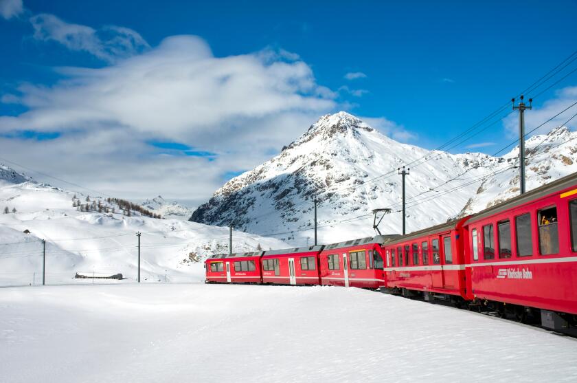 Mountain train at Lago Bianco Bernina Pass in Winter, Grisons, Switzerland | Eisenbahn am Lago Bianco am Bernina Pass im Winter