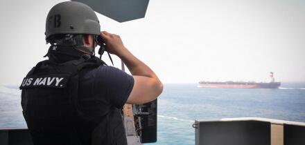 STRAIT OF HORMUZ (July 23, 2017) U.S. Navy Gunner's Mate 3rd Class Jalen Delgado, from Boston, observes passing ships aboard the aircraft carrier USS Nimitz (CVN 68), July 23, 2017, in the Strait of Hormuz. Nimitz is deployed in the U.S. 5th Fleet area of