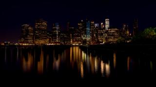 City lights of New York City and water reflection at night