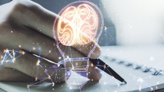 Creative light bulb illustration with human brain and with man hand writing in diary on background, future technology concept. Multiexposure