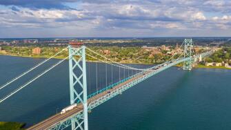 Detroit, Michigan - The Ambassador Bridge, linking the United States (foreground) and Canada over the Detroit River.