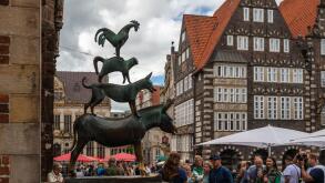 Bremen, Germany - July 16, 2022 : many tourist taking a photo at statue of Town Musicians of Bremen
