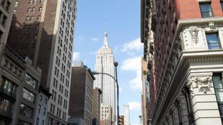 the burton building looking up 5th avenue with view of the empire state building New York City USA