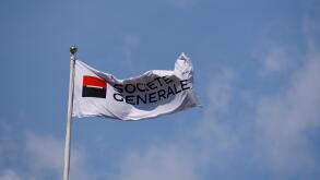 Societe Generale flag flying above the banking business building in Tower Hill, London. Space for copy. Blue sky