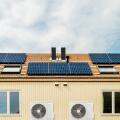 Row of new Dutch houses with solar panels and air-source heat pumps