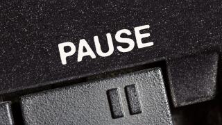 Macro close up photograph of vintage tape machine play and record pause button.