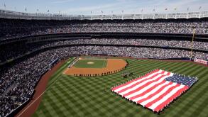 A large flag is unfurled in center field before the New York Yankees home opener against the Cleveland Indians on Thursday, April 16, 2009, in New York at the new Yankee Stadium. (AP Photo/Seth Wenig)