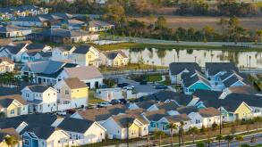 Unfinished frames of inexpensive homes with wooden roof beams under construction. Development of residential housing in US suburbs. Real estate market