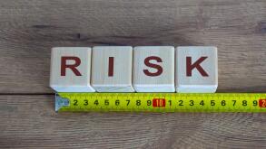 Risk Word On Blocks Arranged Behind The Ruler On Wooden Table
