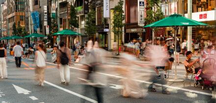 TOKYO, JAPAN - JULY 30 2023: Long exposure motion blurred image of shoppers in the high-end shopping area of Ginza in central Tokyo, Japan
