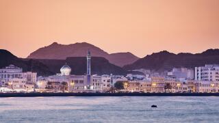 Cityscape view of Muscat city at golden sunset. The capital of Oman.