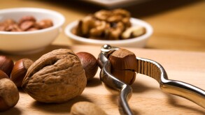 close up of nutcracker, hazelnuts, walnuts, almonds, baked cookies in background. Image shot 10/2008. Exact date unknown.