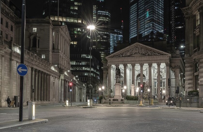 London streets at night near Bank of England building with passing transport