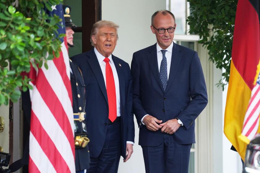 President Donald Trump, left, greets Germany's Chancellor Friedrich Merz at the White House, Thursday, June 5, 2025, in Washington. (AP Photo/Evan Vucci)