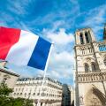 French flag flying in front of Notre Dame Cathedral in Paris, France