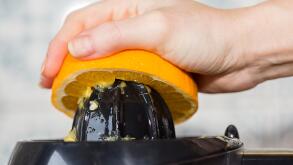 Squeezing orange to extract some healthy juice.