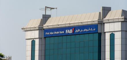 "Ras al Khaimah, Ras al Khaimah/United Arab Emirates - 7/4/2019: "First Abu Dhabi (FAB) Bank blue storefront on a blue sky sunny day. "