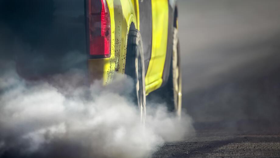 Air pollution from vehicle exhaust pipe on road