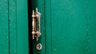 old door ajar with ornate handle