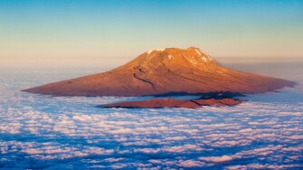 Aerial view of Mount Kilimanjaro lit by the setting sun