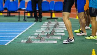 Group of sportsmen before start in sprint running.