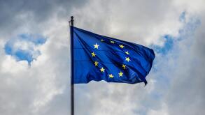 Problem in Europe. Dark and stormy clouds gather over European Union Flag