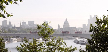 London, UK. Waterloo Bridge, St Paul's Cathedral, River Thames and London Skyline with green trees and red buses