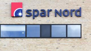 Aalborg, Denmark - July 13, 2017: Spar Nord logo on a wall. Spar Nord is a bank based in North Jutland, Denmark