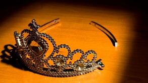 A broken tiara in a rectangular spotlight.