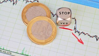 Downtrend financial market chart, red arrow, dices cube with the word STOP and one-euro coins. Selective focus