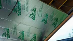 Kingspan insulation being installed on the inside of the roof of a sunroom.