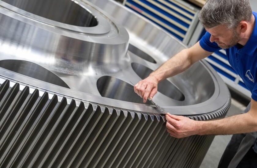 Augsburg, Germany. 08th May, 2023. Robert Wagner inspects a gearwheel at the Renk company. At its Augsburg site, Renk employs around 1,600 people and produces and maintains gearboxes primarily for military use. Credit: Stefan Puchner/dpa/Alamy Live News