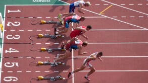 sprinters coming out of their starting blocks one of them too fast. Image shot 2003. Exact date unknown.